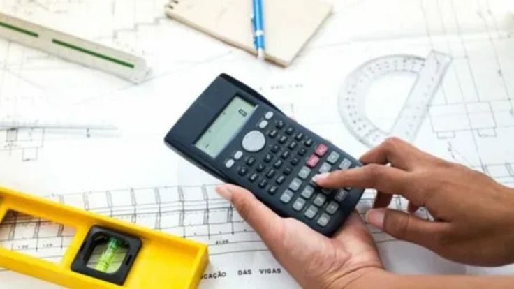 Person using calculator on architectural blueprints, with drafting tools in view.