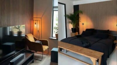 Modern bedroom with cozy lighting, wooden accents, stylish armchair, and plants by the windowsill.