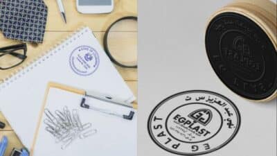 Office supplies and rubber stamp set on desk displaying an EG Plast seal with stationery elements and a design sketch.