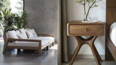 Modern wooden sofa and stylish bedside table in minimalist living space with greenery.