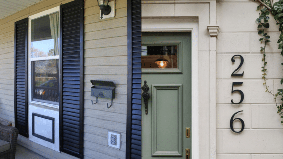 Viewing Deck Blog 4 Front porch with black shutters and mailbox, adjacent to a green door marked 256, surrounded by light siding and ivy. | Sky Rye Design Front porch with black shutters and mailbox, adjacent to a green door marked 256, surrounded by light siding and ivy.
