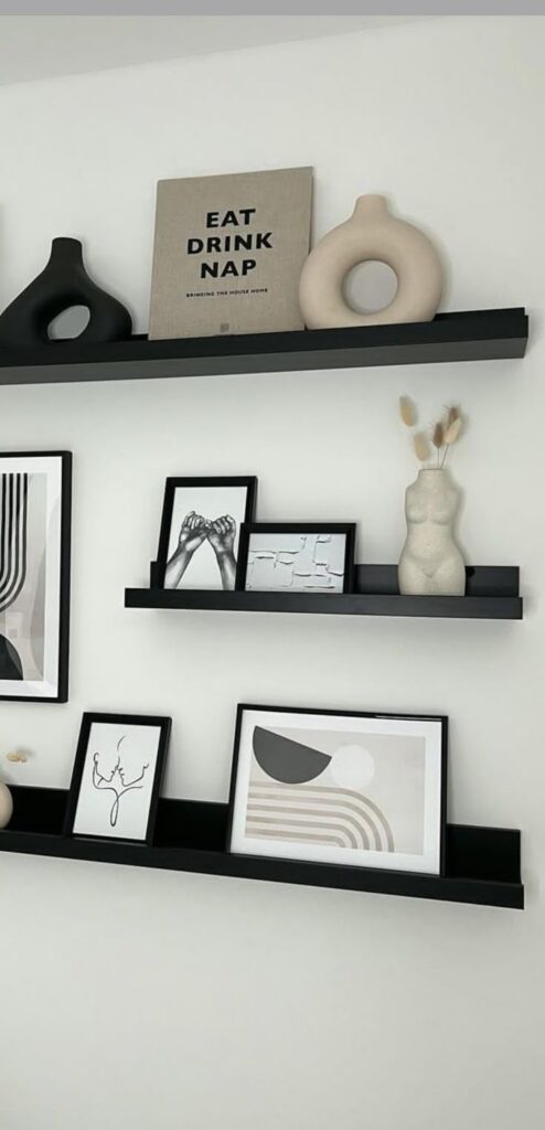 Modern black shelves with minimalist decor, abstract art, unique vases, and stylish home accents.