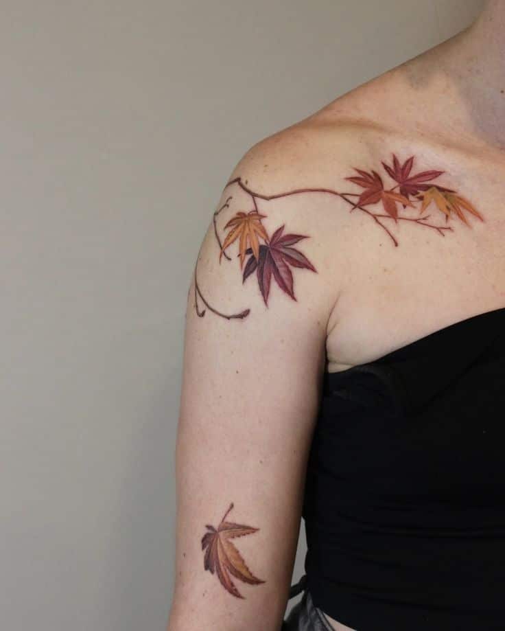 d1b96b44-e0d8-4547-9d82-be602edf1e9c Autumn leaves tattoo on shoulder and arm, featuring vivid red and orange hues on a pale skin background. | Sky Rye Design Autumn leaves tattoo on shoulder and arm, featuring vivid red and orange hues on a pale skin background.