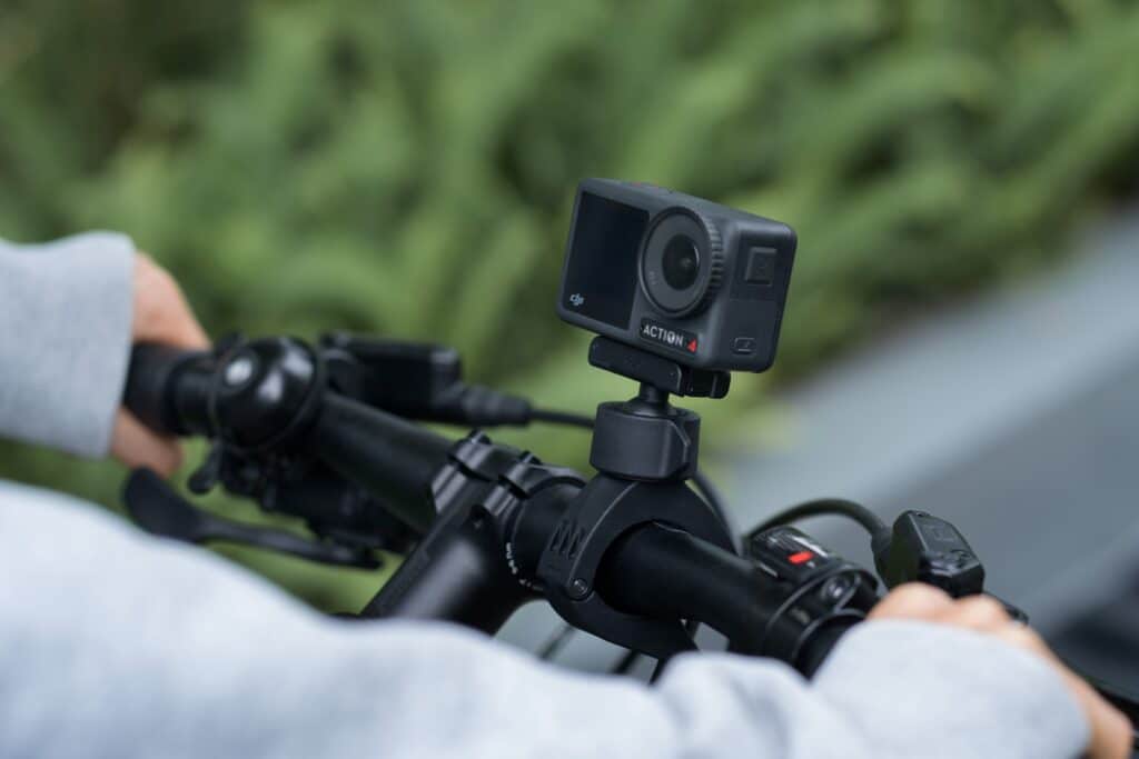 Action camera mounted on a bicycle handlebar, ready for outdoor adventure filming.