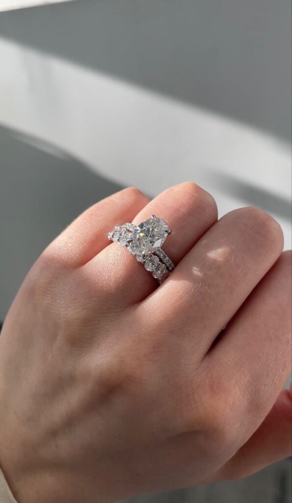 Person wearing a diamond engagement ring and a band on left hand.