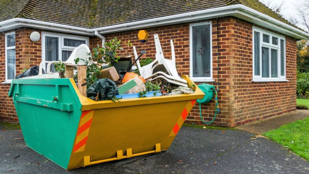 House with a full waste skip outside, ready for disposal and recycling.