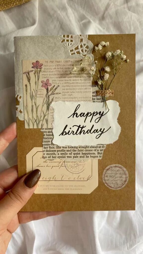 Handcrafted birthday card with dried flowers, vintage paper, and 'happy birthday' text. Perfect for a unique celebration.