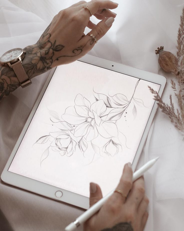 Digital flower sketch on tablet with stylus, tattooed hand holding pen, watch on wrist, creative art scene.