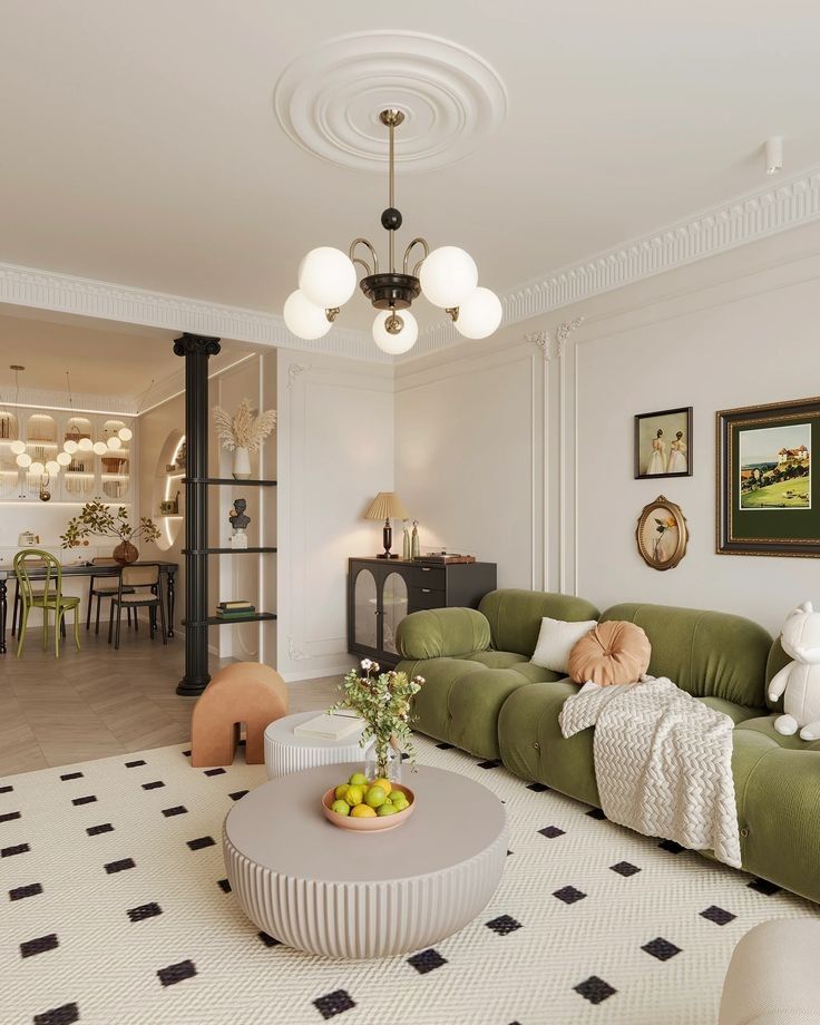 Spacious living room with green sofa, modern chandelier, round tables, and stylish decor in neutral tones.