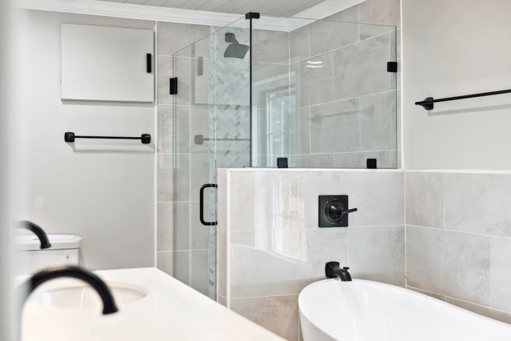 image Minimalist bathroom with glass shower, white tub, and modern fixtures. Elegant and bright design. | Sky Rye Design Minimalist bathroom with glass shower, white tub, and modern fixtures. Elegant and bright design.