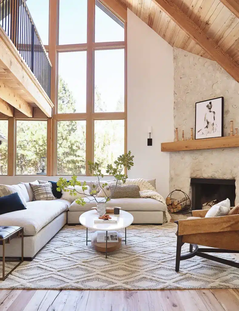 Scandinavian-inspired living room with large windows, cozy sofa, and modern fireplace.