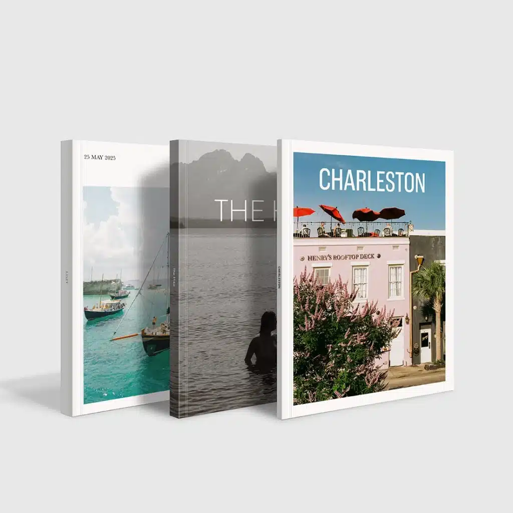 Three stylish travel books with covers featuring boats, a serene lake scene, and a colorful Charleston rooftop view.