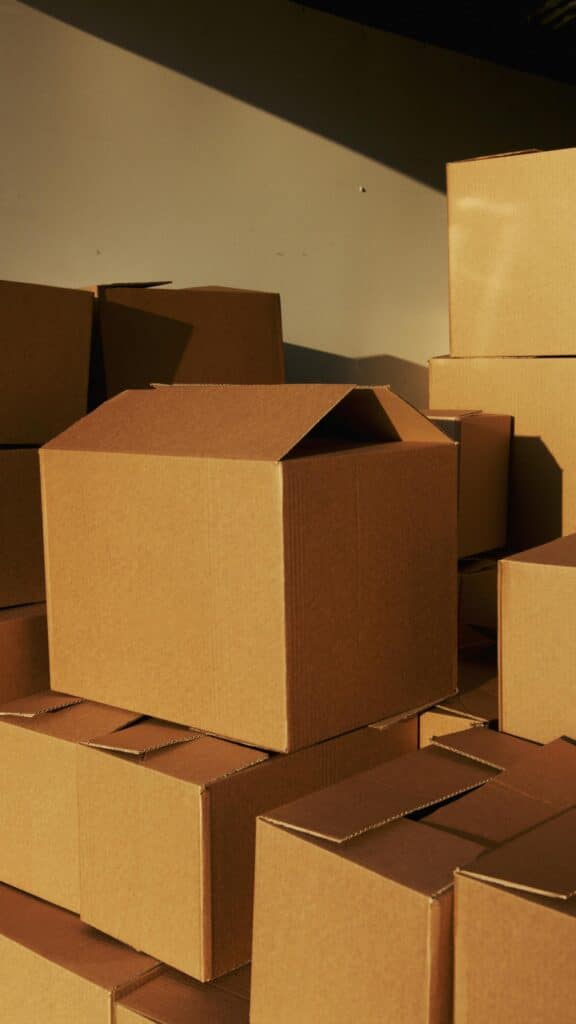 Stacks of brown cardboard boxes organized neatly in a storage space, ready for shipping or moving.