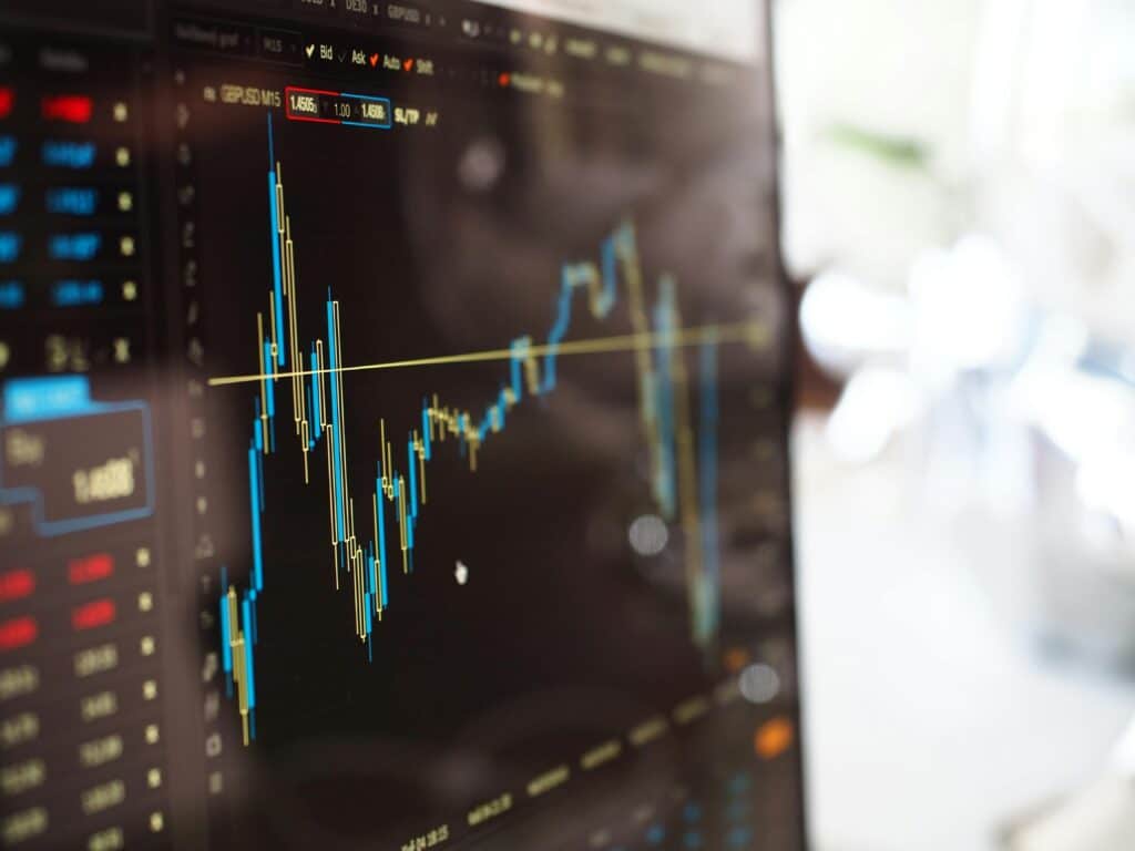 Close-up of a financial trading screen displaying stock market data and candlestick charts for market analysis.