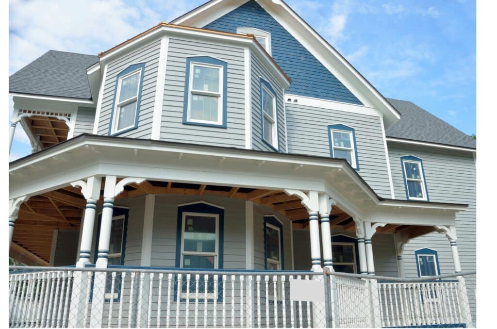 pexels-pixabay-158730 Victorian-style house with gray siding, blue trim, and large porch against a clear sky. | Sky Rye Design Victorian-style house with gray siding, blue trim, and large porch against a clear sky.