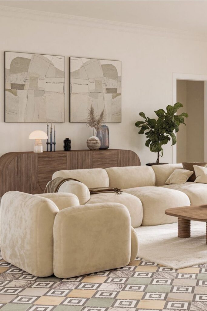 Modern living room with beige sofa, abstract paintings, wooden sideboard, and green potted plant. Cozy interior design.