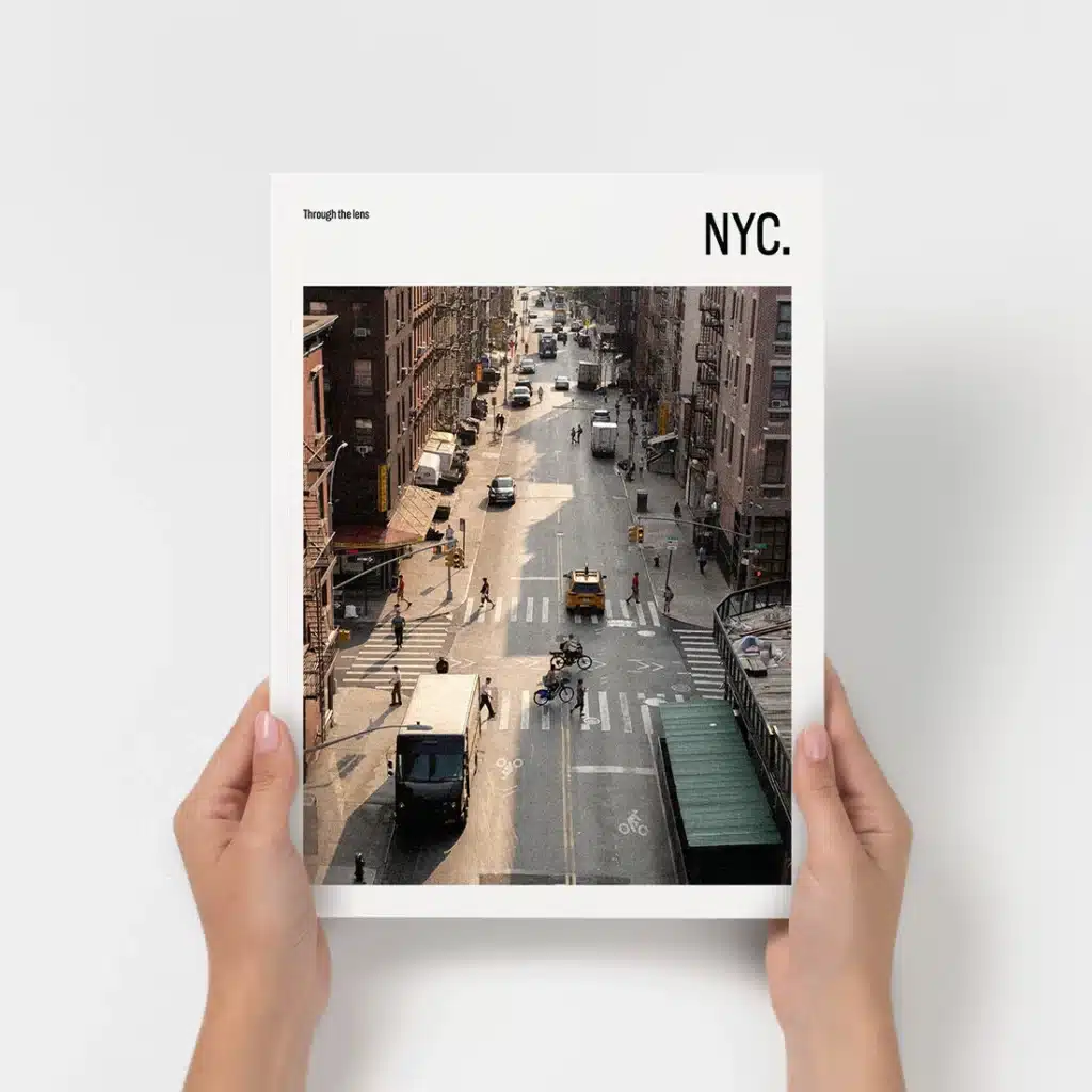 Hands holding a New York City street scene photo book titled NYC.
