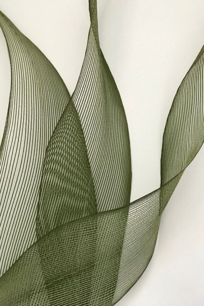 Abstract green feather-like lines on a white background, creating an intricate and delicate pattern.