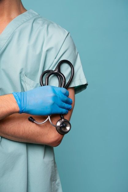 Healthcare professional in scrubs with stethoscope and gloves, conveying medical expertise and readiness.
