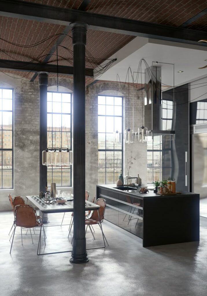 Modern industrial kitchen with brick ceiling, large windows, black island, and dining table with leather chairs.