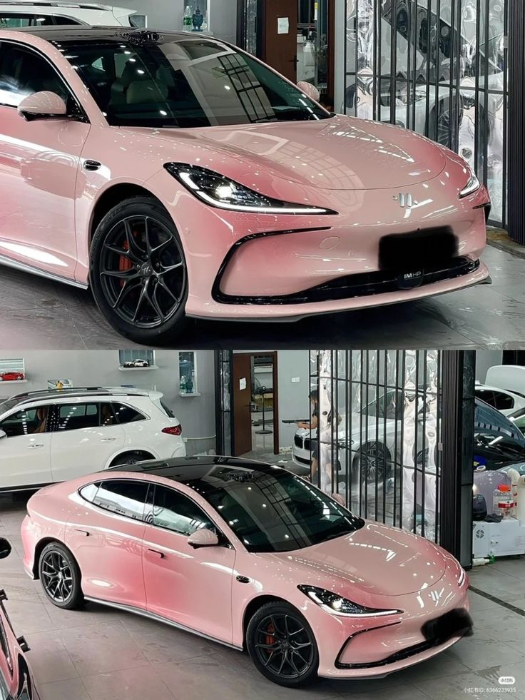 Sleek pink electric car with black roof and sporty design showcased in modern showroom.