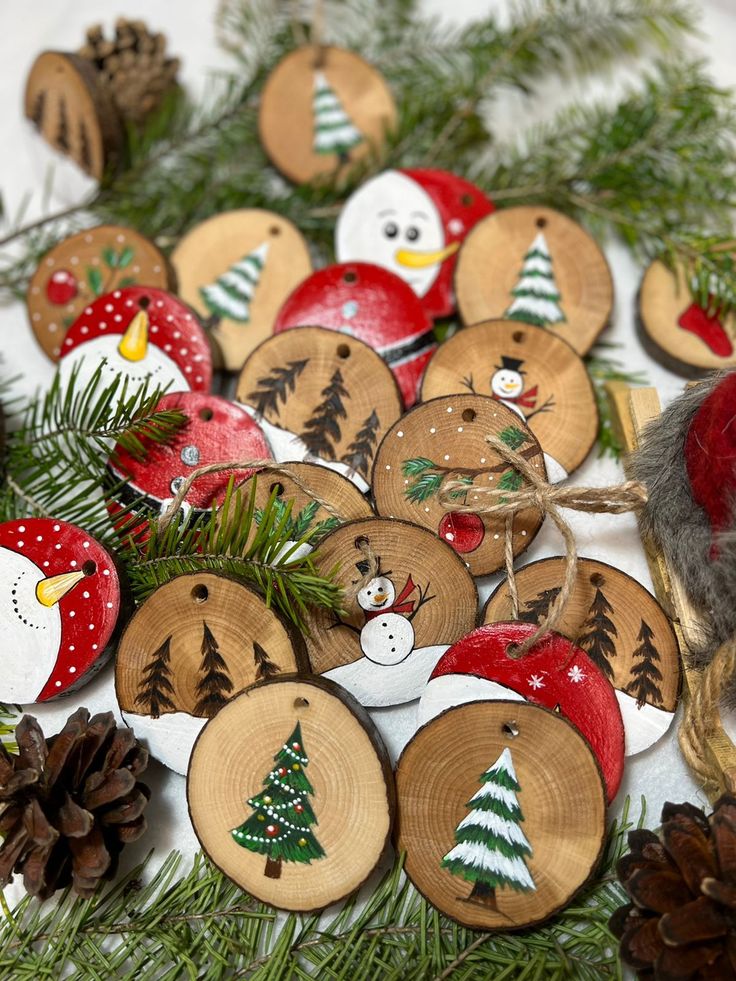 Елочные игрушки из спилов Hand-painted wooden Christmas ornaments with trees and snowmen on a festive green pine backdrop. | Sky Rye Design Hand-painted wooden Christmas ornaments with trees and snowmen on a festive green pine backdrop.