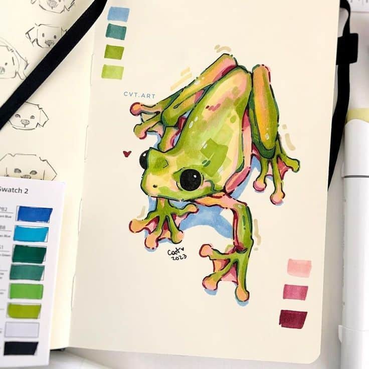 Colorful frog illustration in sketchbook with paint swatches, showcasing vibrant greens and pinks.