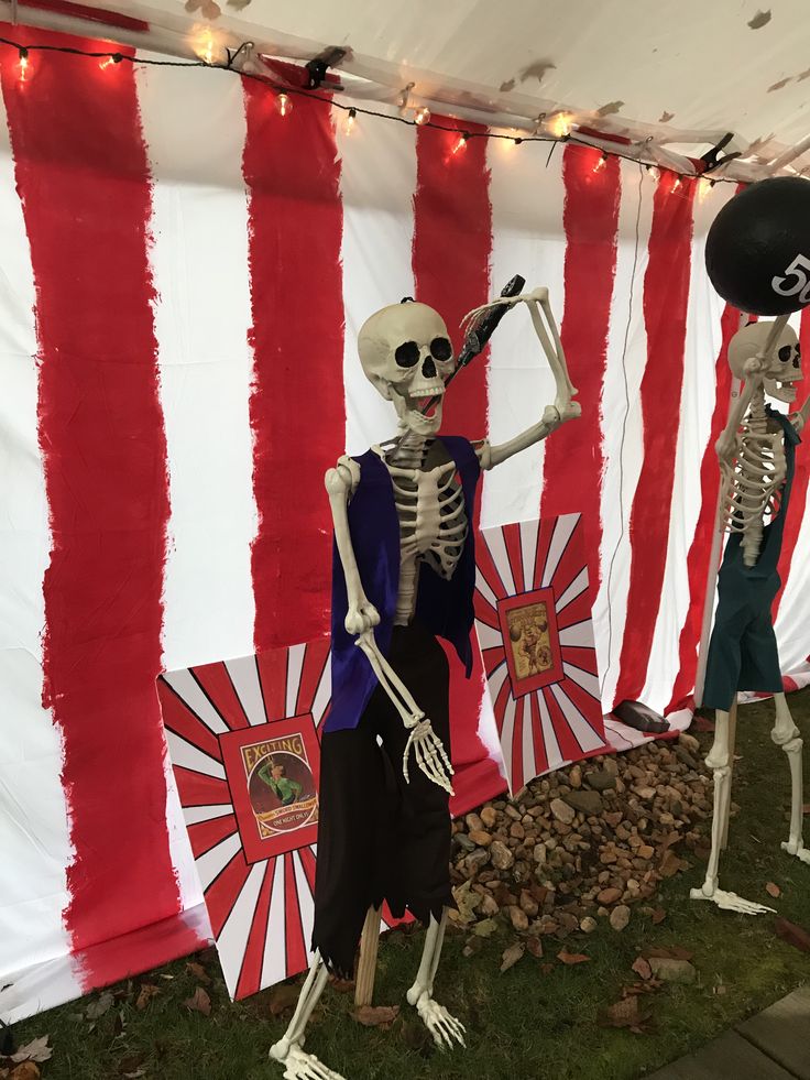 Skeleton decor at a carnival-themed Halloween party with red and white striped backdrop.