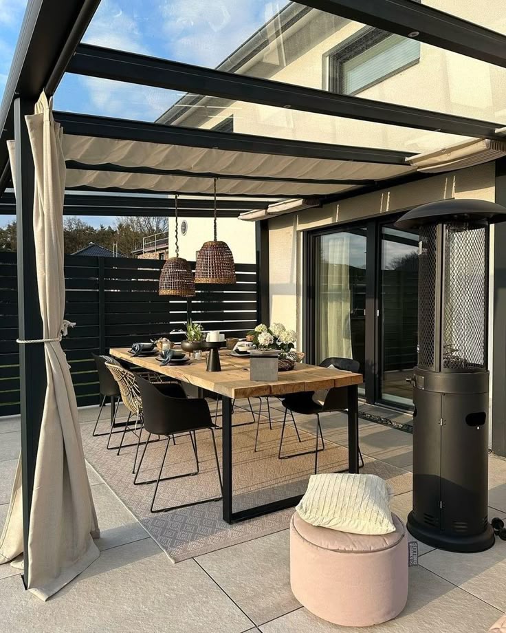 _ 1 Modern outdoor dining area with pergola, table, chairs, pendant lights, and patio heater for cozy gatherings. | Sky Rye Design Modern outdoor dining area with pergola, table, chairs, pendant lights, and patio heater for cozy gatherings.