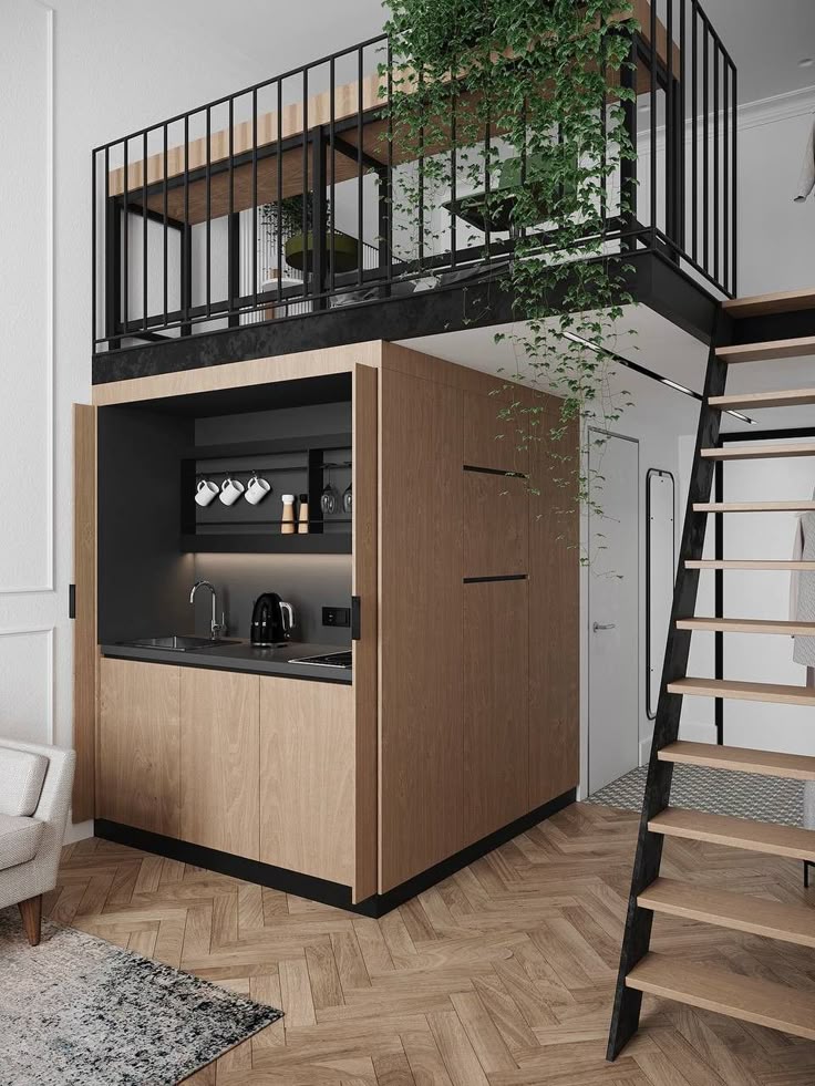 Modern tiny apartment with loft bedroom, cozy kitchenette, and wooden staircase for compact living.