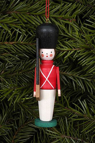 _ 10 Wooden toy soldier ornament hanging on a Christmas tree, featuring a red uniform and black hat. | Sky Rye Design Wooden toy soldier ornament hanging on a Christmas tree, featuring a red uniform and black hat.