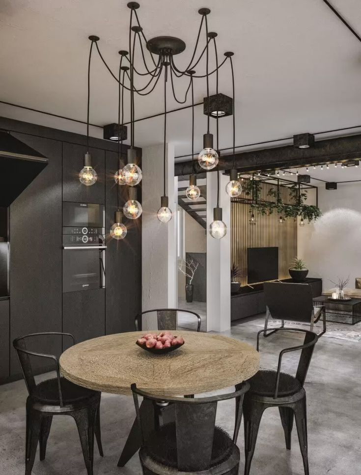 Modern dining area with industrial pendant lights, wooden table, black chairs, and a stylish open-plan living room.