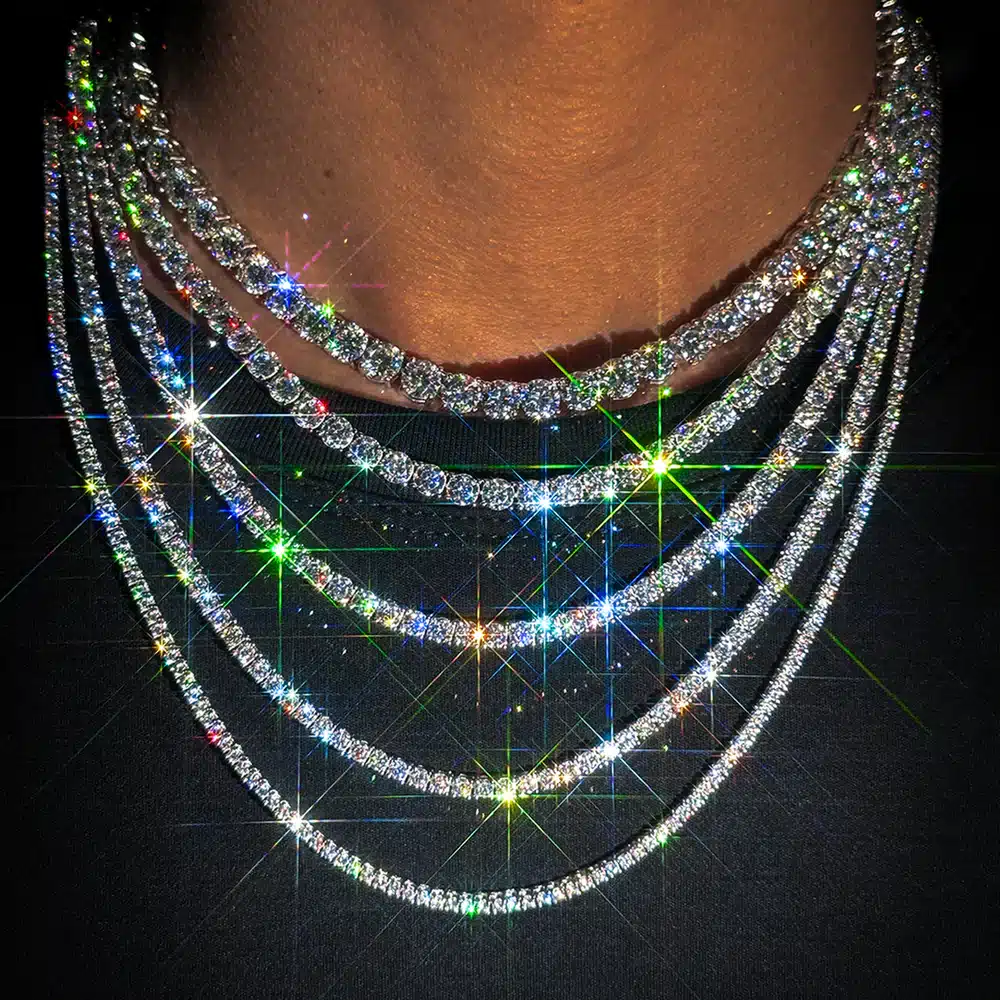 Sparkling diamond necklaces creating a rainbow effect on a dark background.