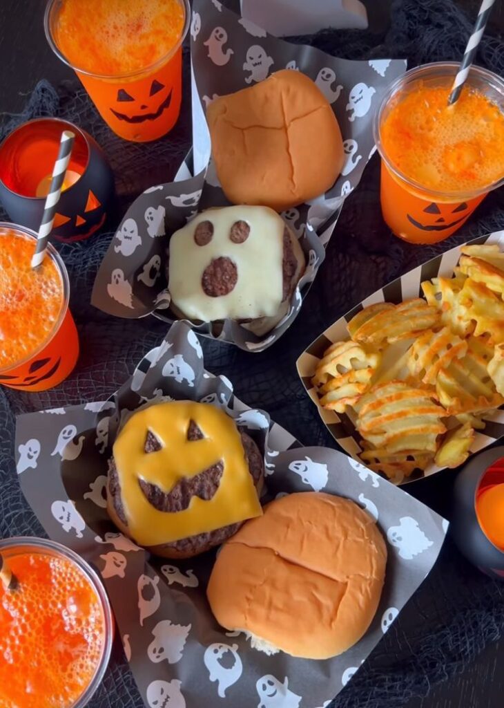 _ 15 Halloween-themed burgers and drinks with jack-o'-lantern and ghost designs, served with waffle fries. | Sky Rye Design Halloween-themed burgers and drinks with jack-o'-lantern and ghost designs, served with waffle fries.