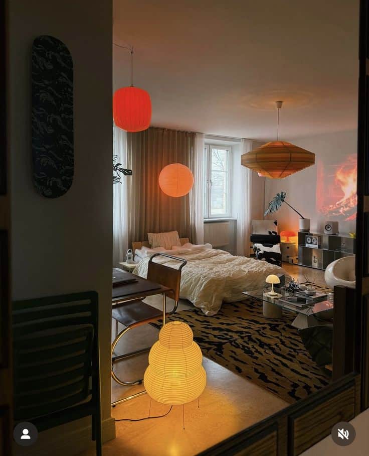 Cozy bedroom with ambient lighting, featuring modern lamps, a comfy bed, and stylish decor elements.