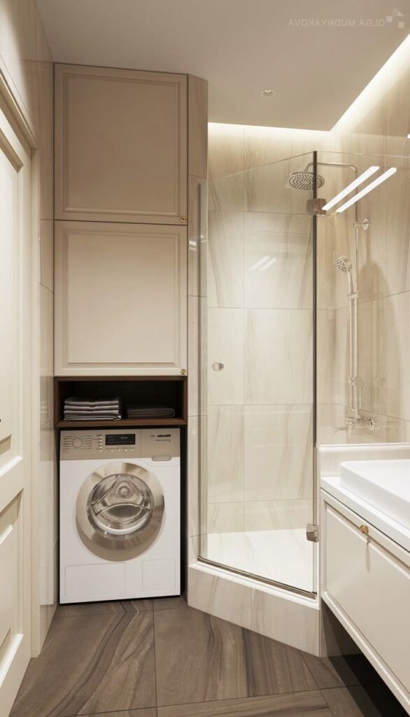 Minimalist bathroom with glass shower, washing machine, tile flooring, and white cabinets.