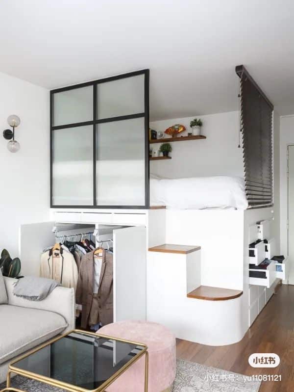 Stylish small apartment with loft bed, wardrobe, and cozy seating area, maximizing space and modern design.