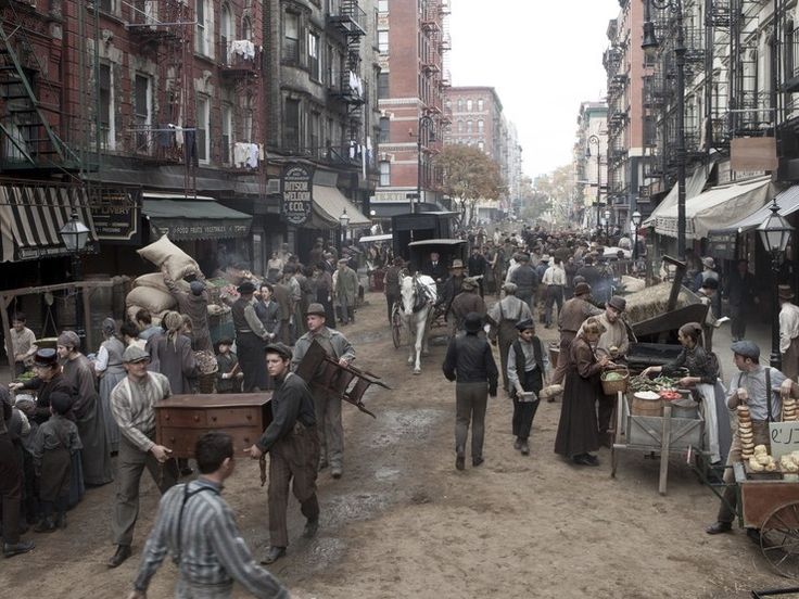 Historical bustling city street market with people, food carts, and horse-drawn carriages in an urban setting.