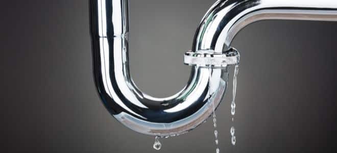 _ 2 Leaking chrome pipe with dripping water in dark background. | Sky Rye Design Leaking chrome pipe with dripping water in dark background.