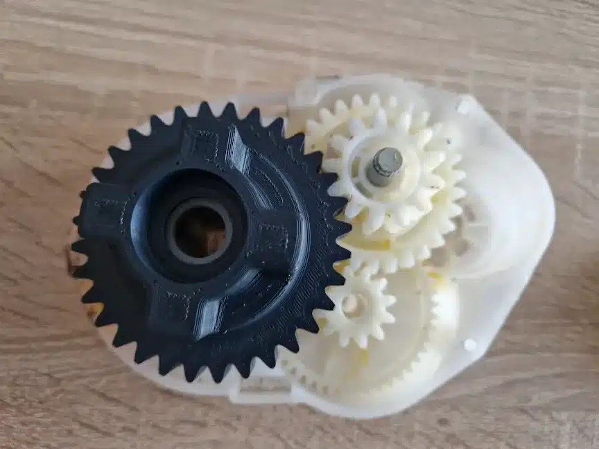 Close-up of interlocking gears on a table, showcasing intricate mechanical design.