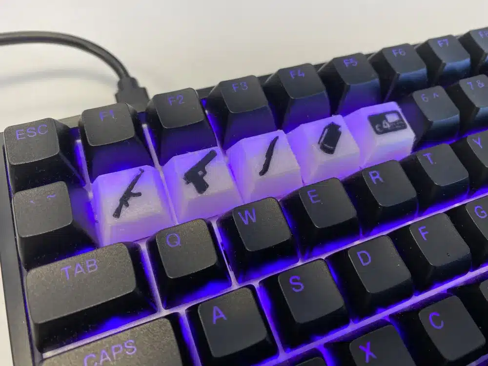 Custom gaming keyboard with weapon-themed keycaps and purple backlighting.