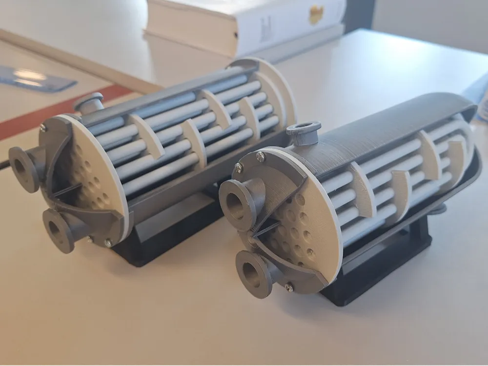 3D printed industrial filter models on a desk, showcasing detailed engineering design.
