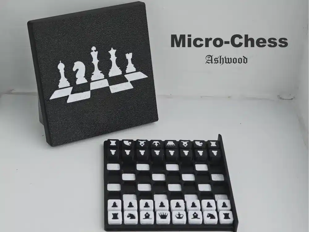 Mini chess set titled Micro-Chess Ashwood with compact black and white board and storage box.