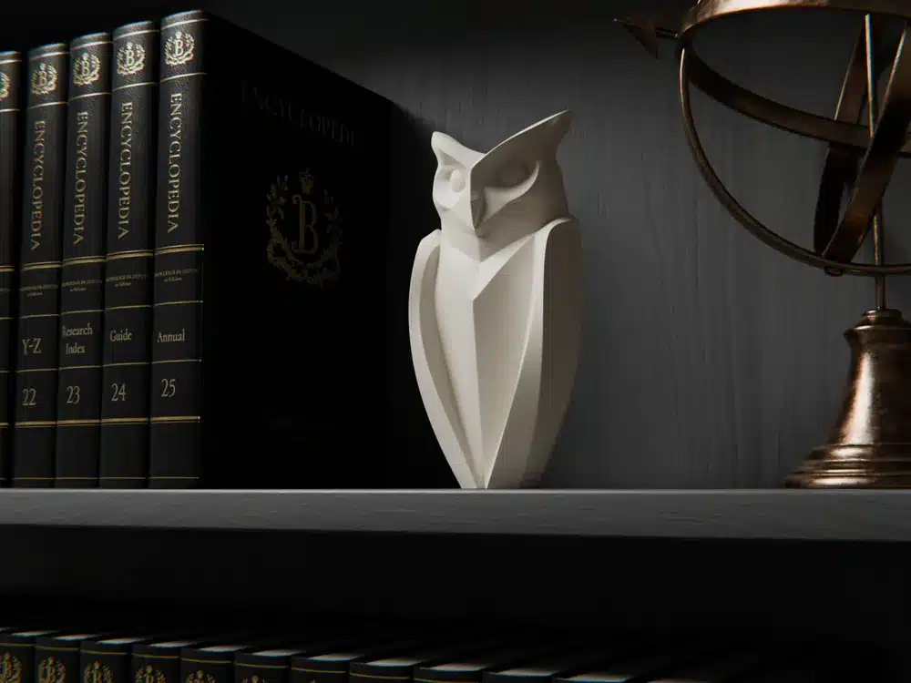 Sleek owl sculpture on bookshelf with encyclopedias and globe, accentuating elegance and knowledge.