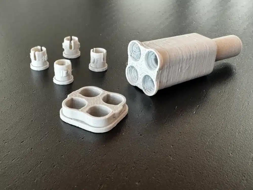 3D-printed lock picking tool and pins set on a dark surface, showcasing multiple components.