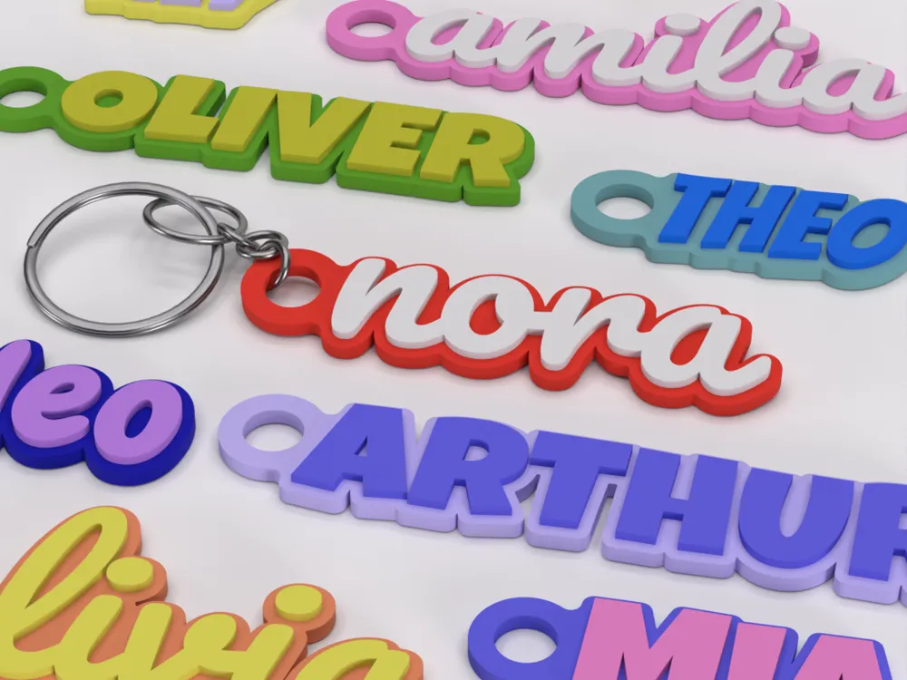 Colorful personalized name keychains on display, featuring various names in vibrant 3D lettering.