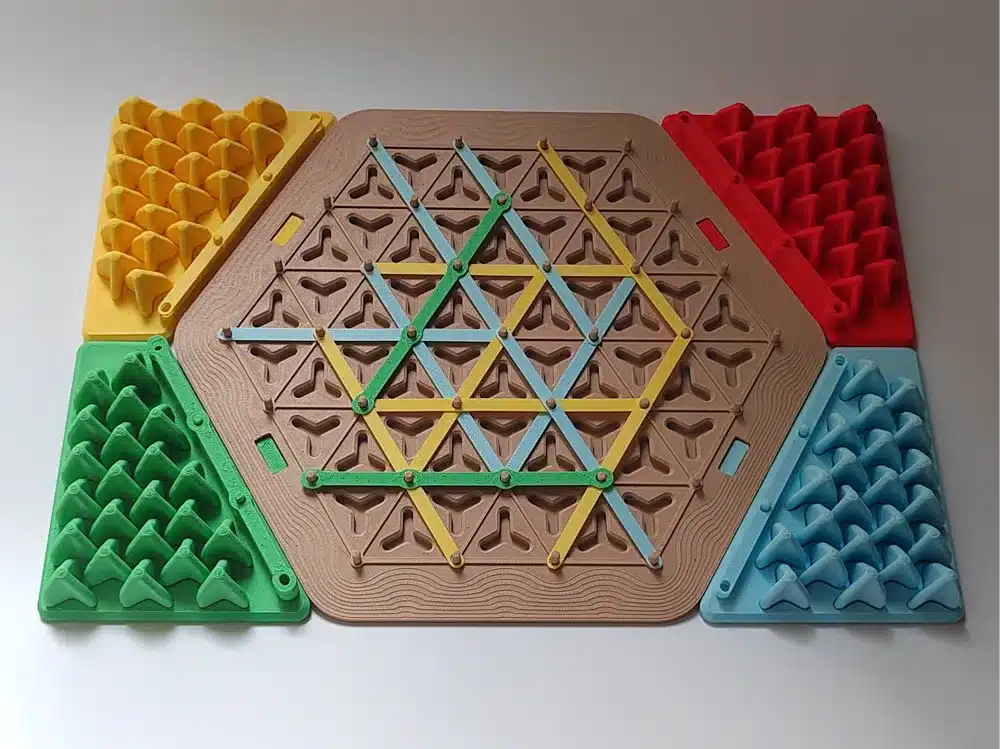 Colorful geometric board game with hexagonal and triangular patterns on a flat surface, featuring vibrant pieces.