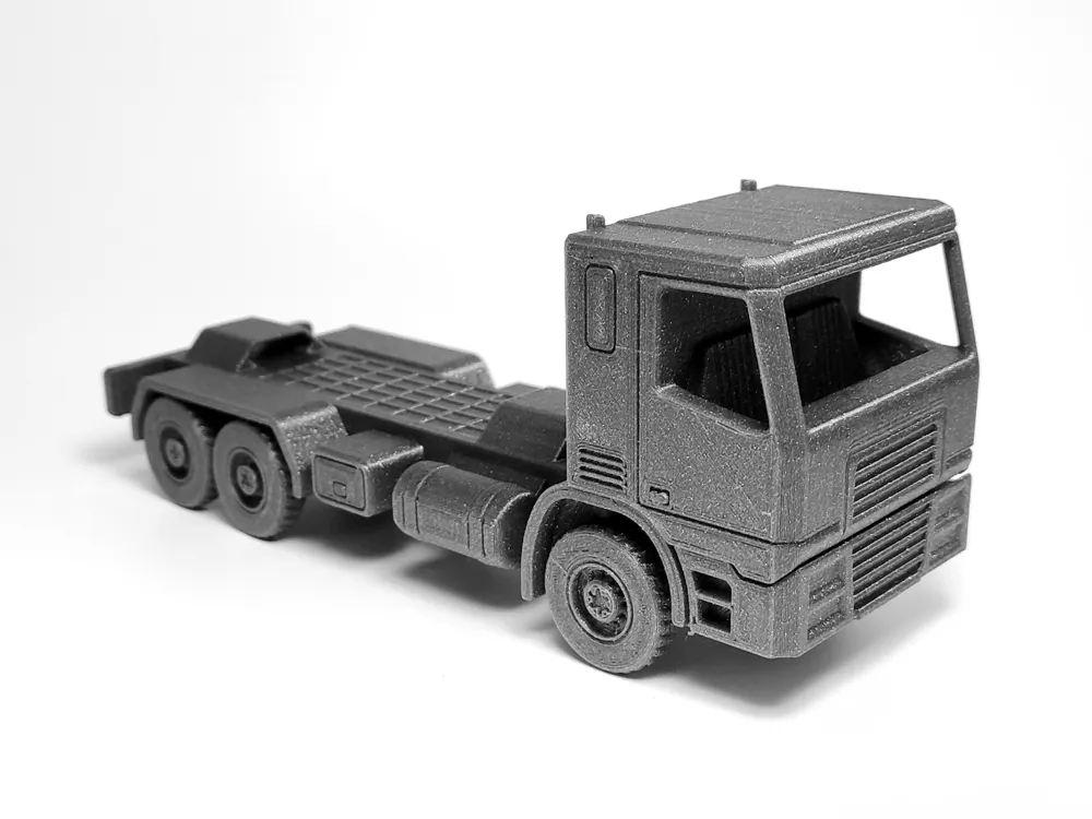 Black die-cast model truck with detailed exterior, shown on a white background.