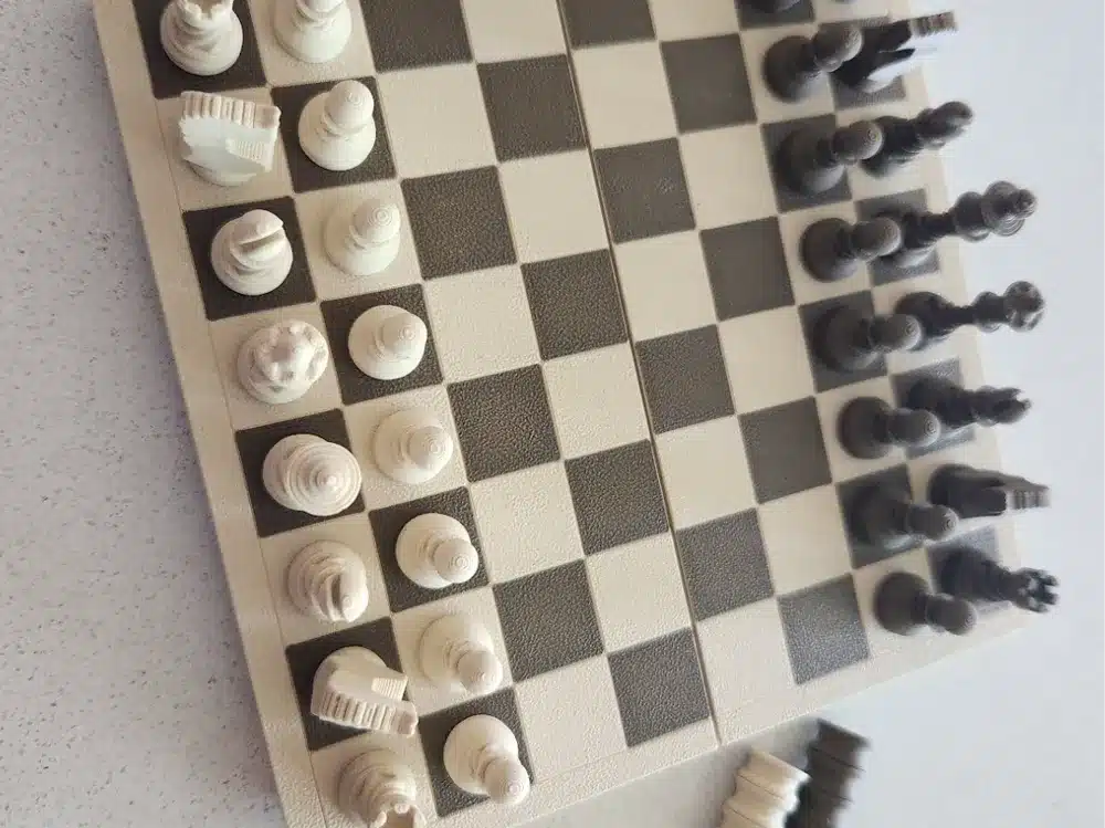 Unique chess pieces on a checkered board, ready for a game from an overhead view.