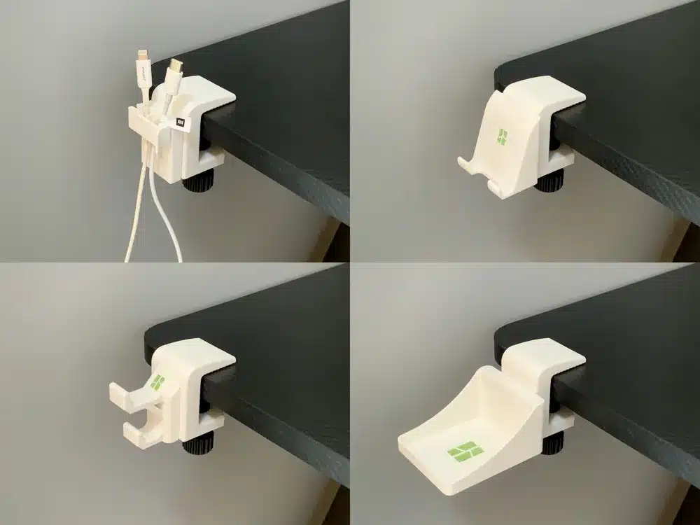 Modular desk organizer with adaptable clips and holders for cables and devices, attached to a black desk edge.